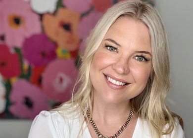 Smiling individual at Magnetic Glow, Redcliffe, Queensland, AU with floral art background.