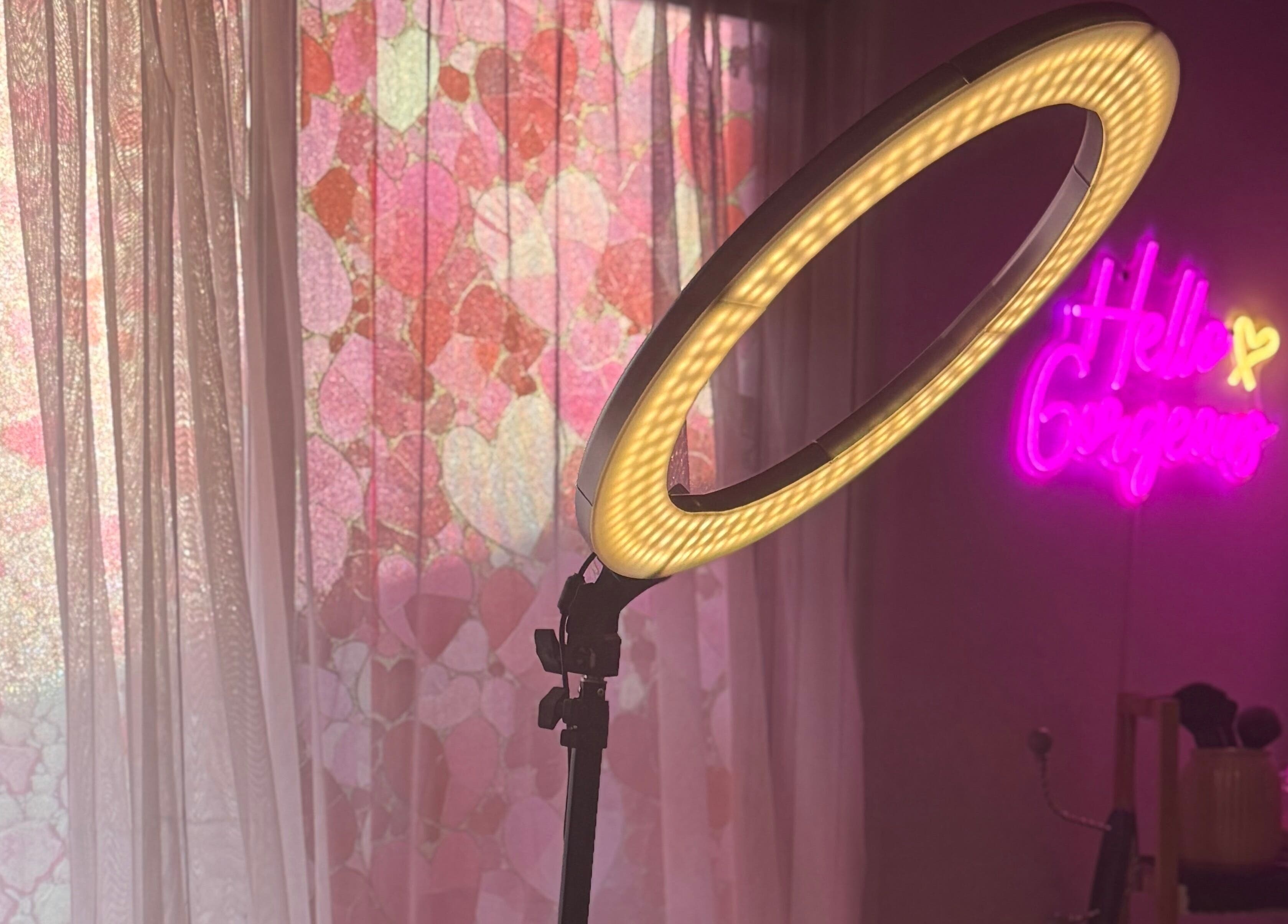 Glamorous lighting setup at Magnetic Glow, Redcliffe, Queensland, AU, with neon sign and pink decor.