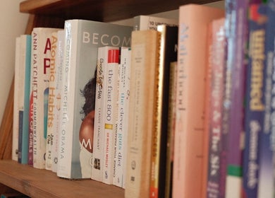 Bookshelf in Magnetic Glow's lounge area, Redcliffe, Queensland, AU, adding a cozy reading ambiance.