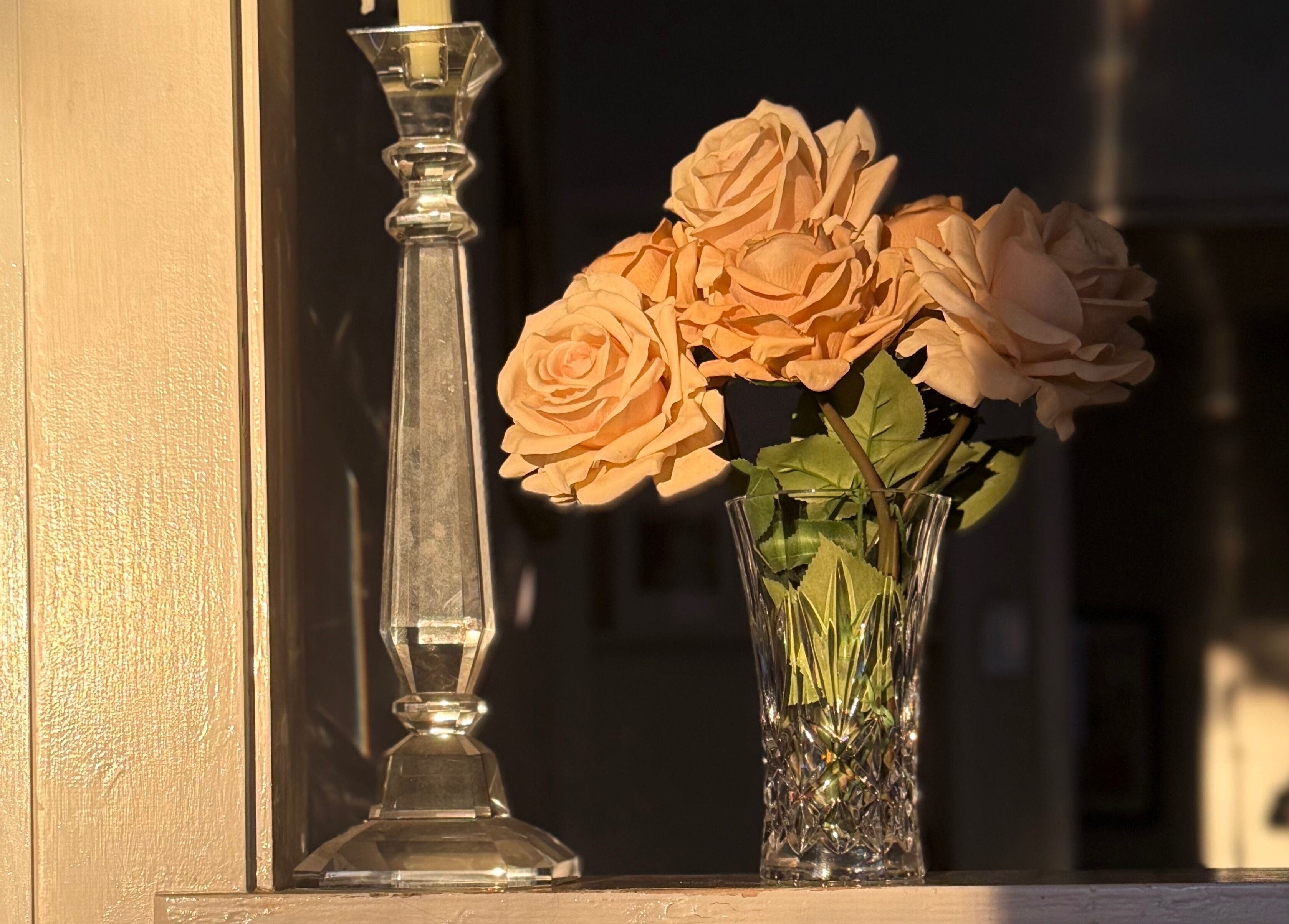 Elegant roses in a vase with candlelight at Magnetic Glow, Redcliffe, Queensland, AU.