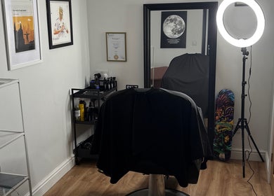 Modern and stylish interior of Illusion Barbers, Cannock, England, GB with a sleek chair and vibrant decor.