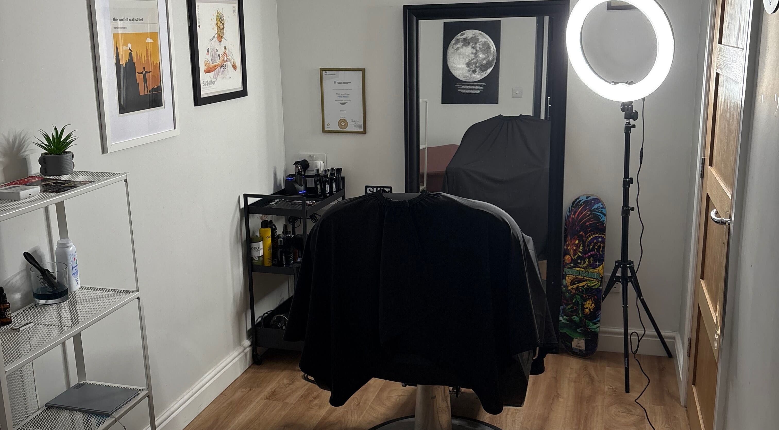Modern and stylish interior of Illusion Barbers, Cannock, England, GB with a sleek chair and vibrant decor.