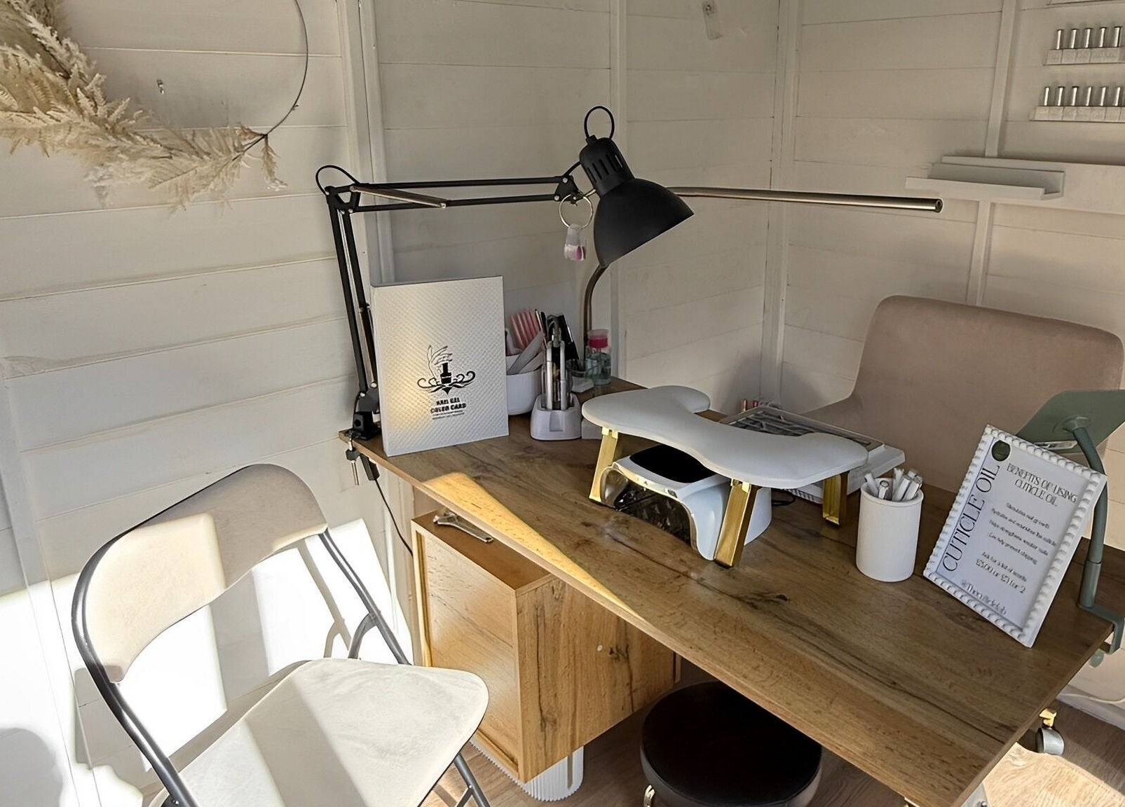 Manicure station at Polished by Kate in Constantine, England, GB, featuring stylish decor and tools.