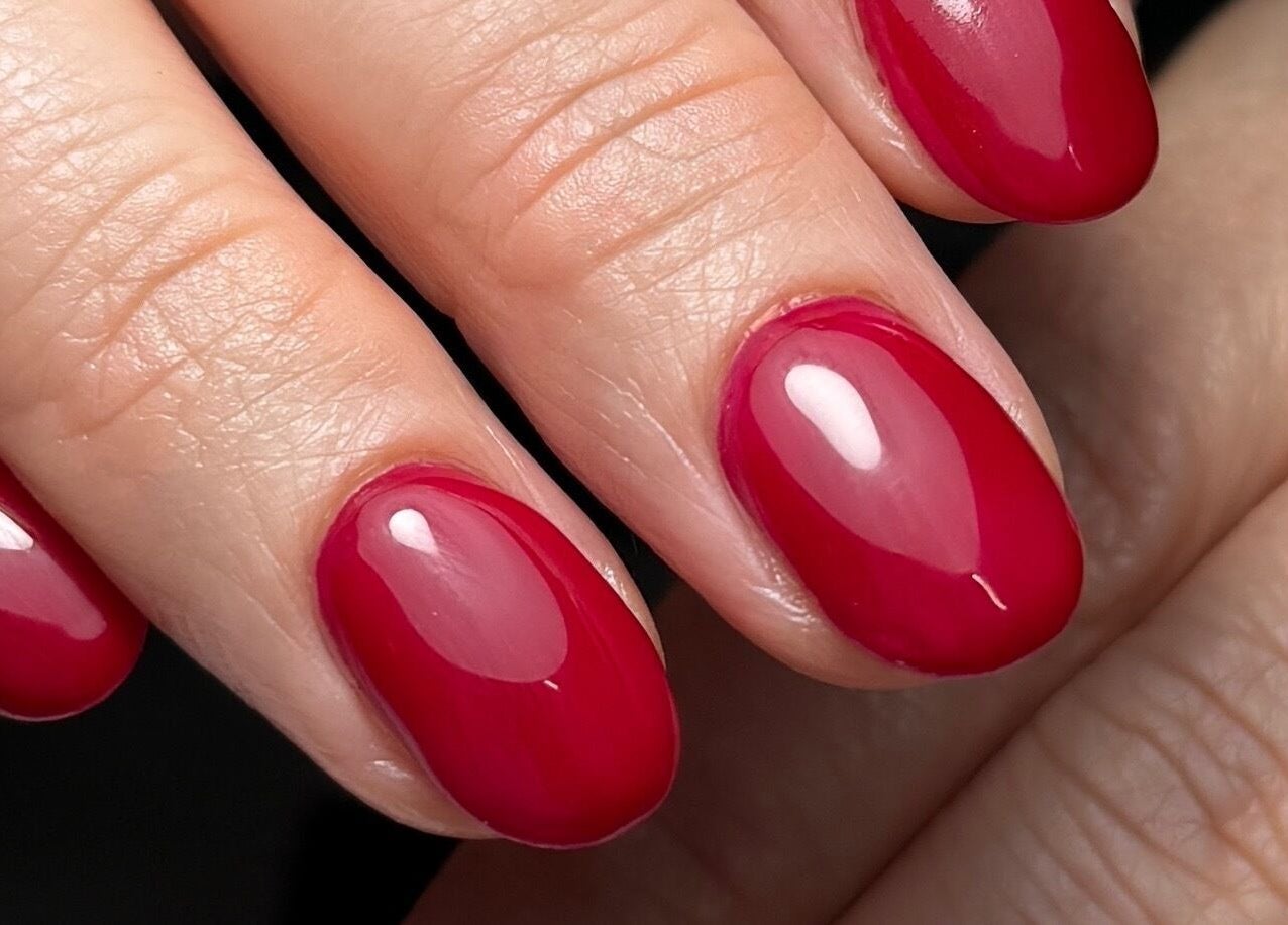 Elegant red manicure at Polished by Kate in Constantine, England, GB showcasing detailed nail art.