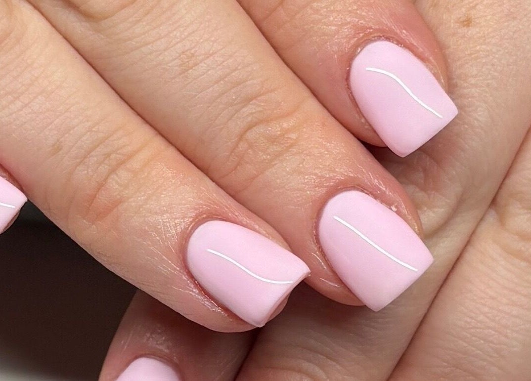 Elegant pastel pink nails with fine lines at Polished by Kate, Constantine, England, GB showcasing chic nail art.