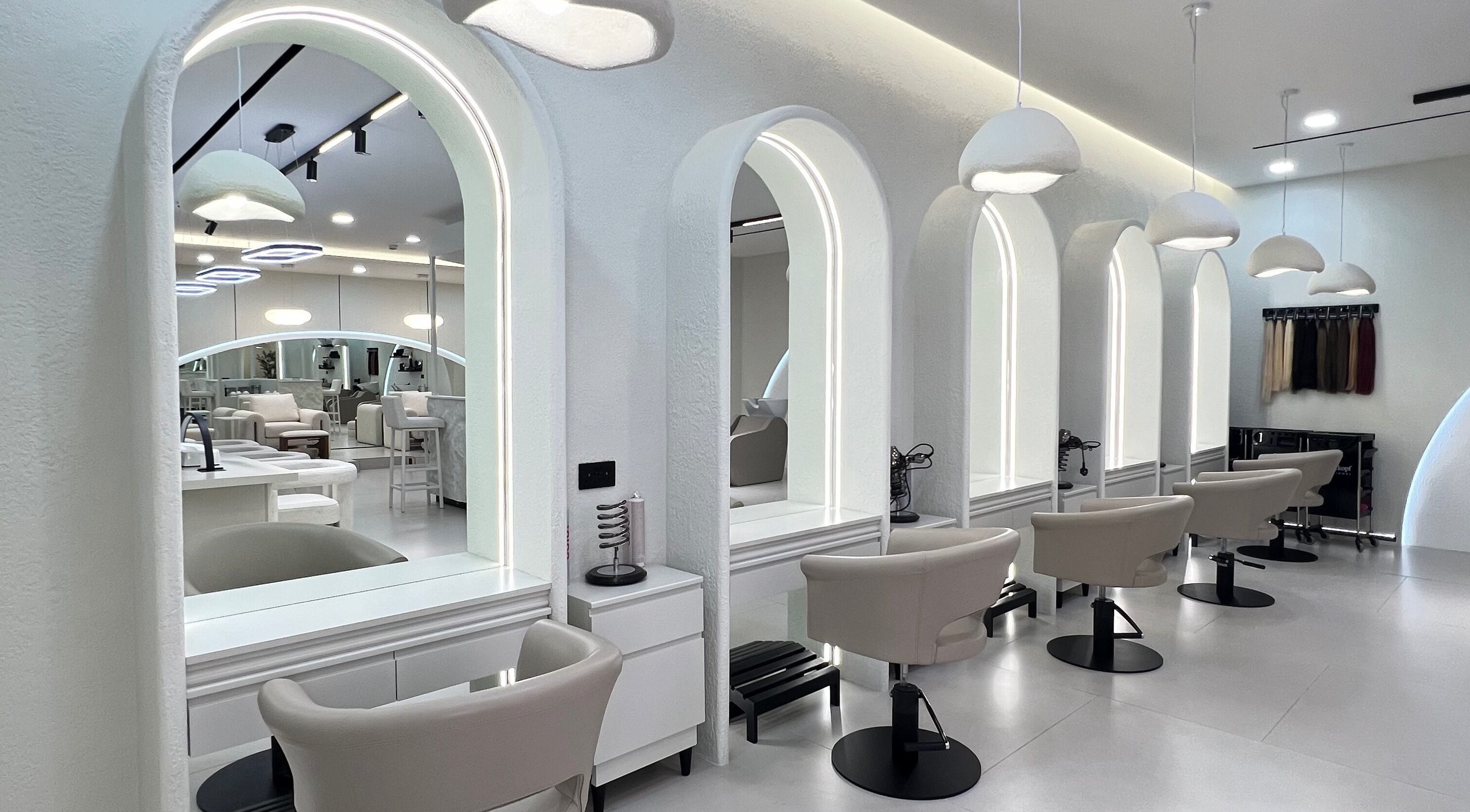 Elegant interior of Emeraude Beauty Salon, Dubai with stylish mirrors and plush chairs.