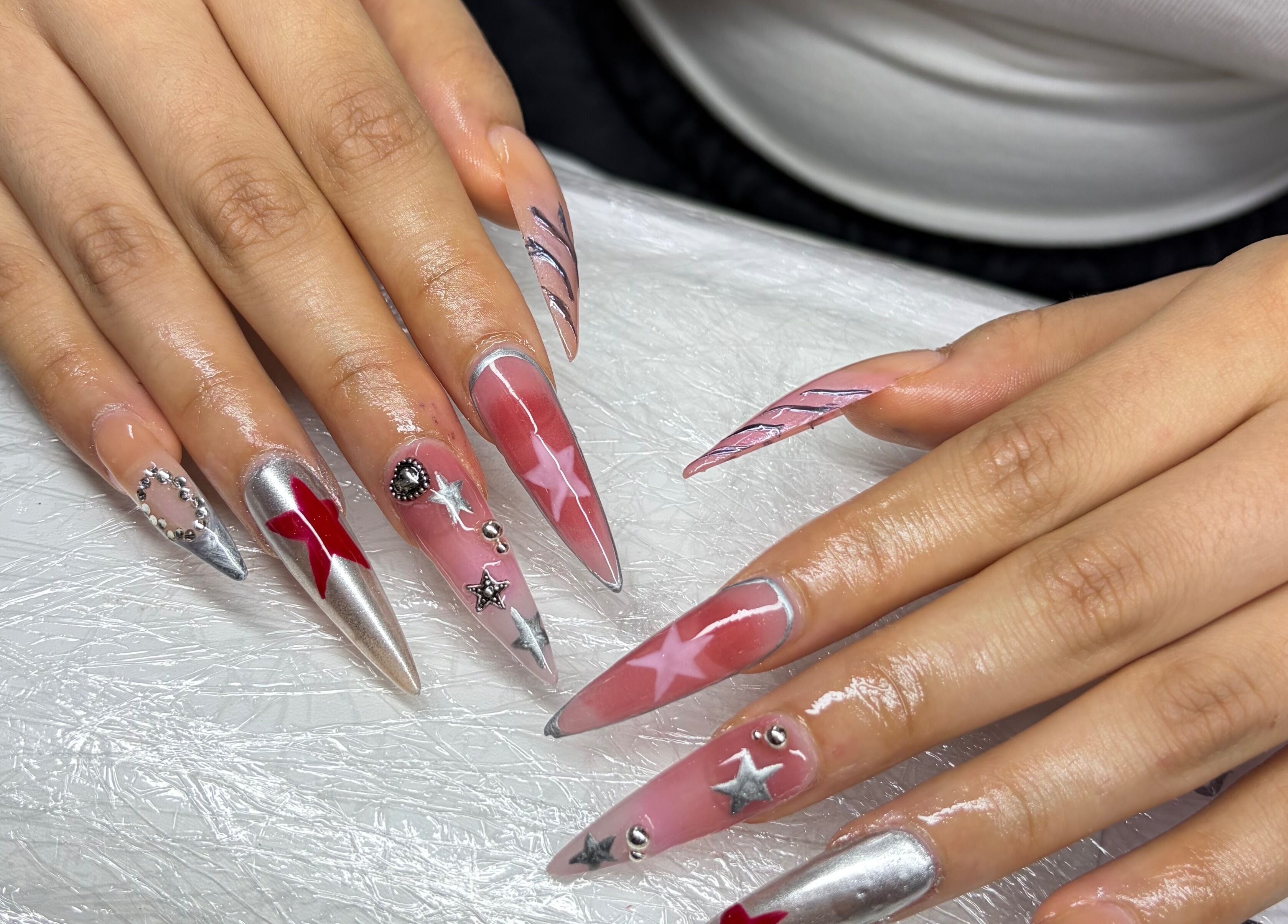 Chester Hill nails and eyelash extension studio showcases intricate star-studded nails in Sefton, New South Wales, AU.