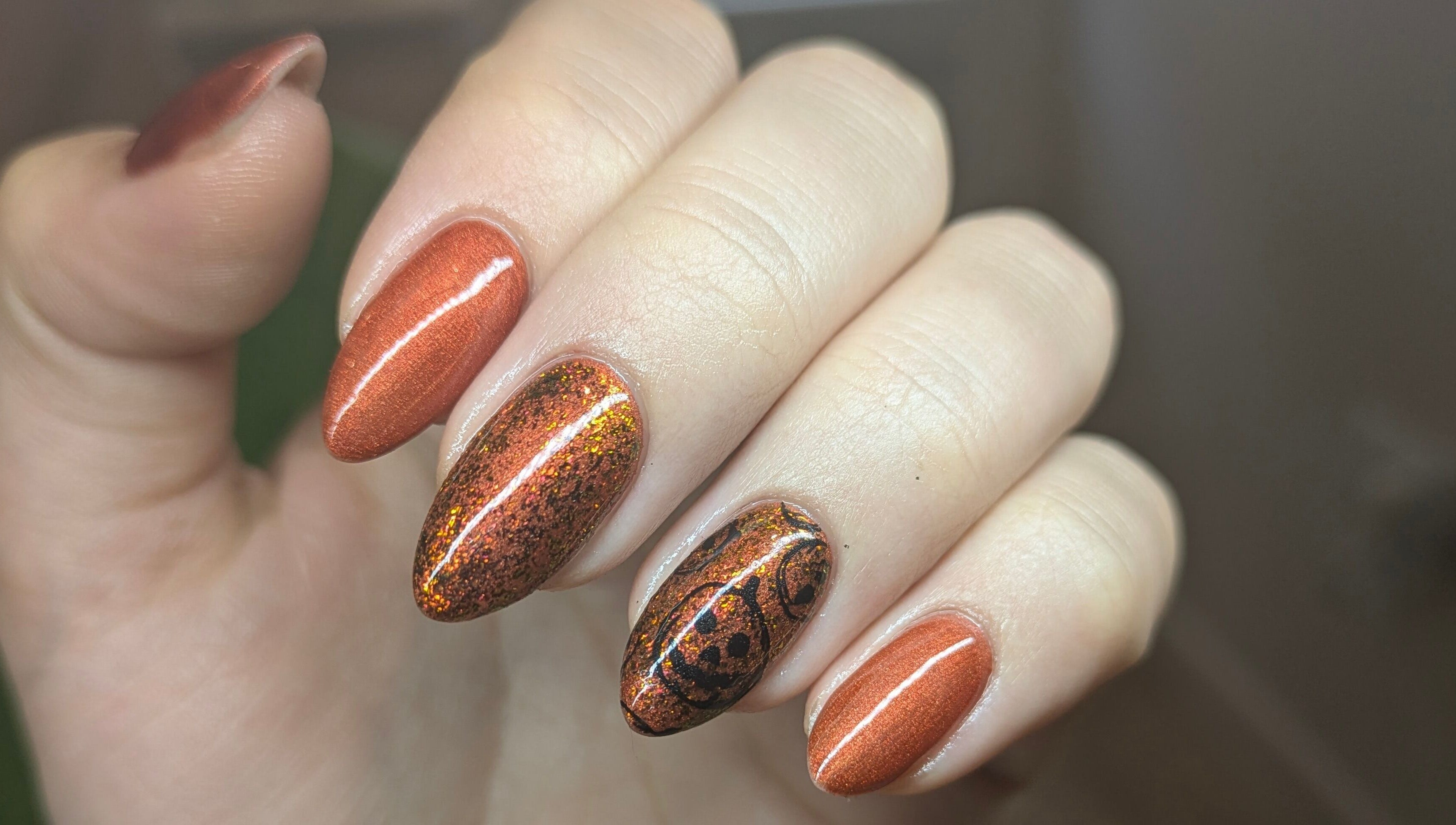 Gleaming copper-colored nails with intricate design at The Nail Alchemist, Knaresborough, England, GB.