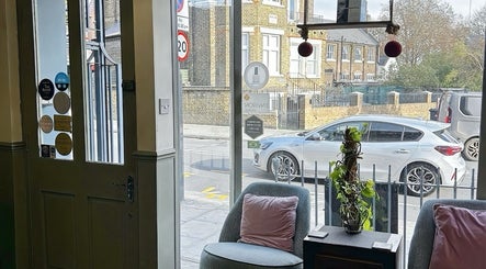 Cozy seating area at Jessica Maia Beauty, London, England, GB, with street view and soft pastel decor.