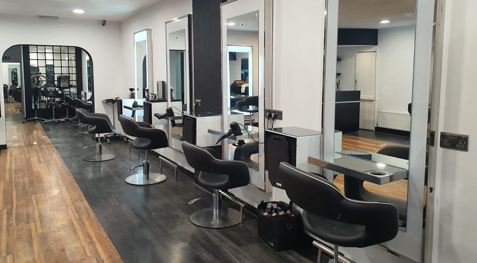Modern styling chairs at Amo Aesthetics in Orpington, England, GB, reflecting a sleek and inviting salon interior.