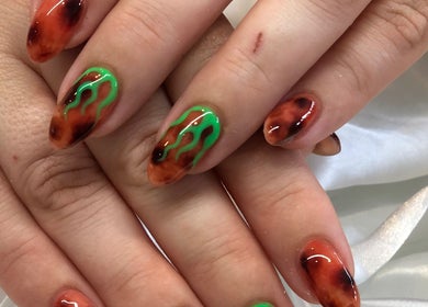 Vibrant nail art at Lumi Haus Beauty Bar, Goldcoast, Queensland, AU. Fiery design with unique green accents.
