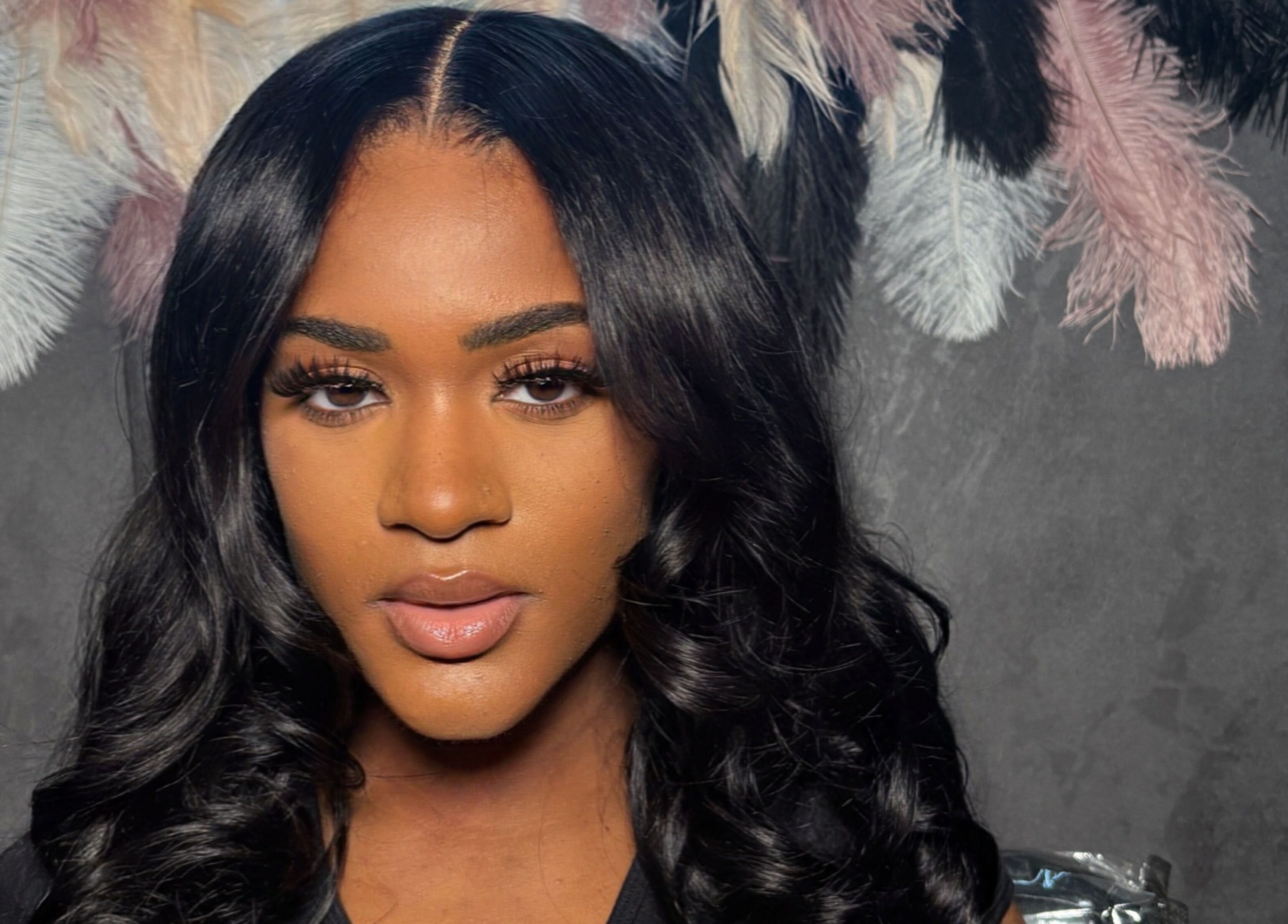 Professional hair styling at ChicBy.Te, Oistins, Christ Church, BB, showcasing sleek curls and feathered decor.