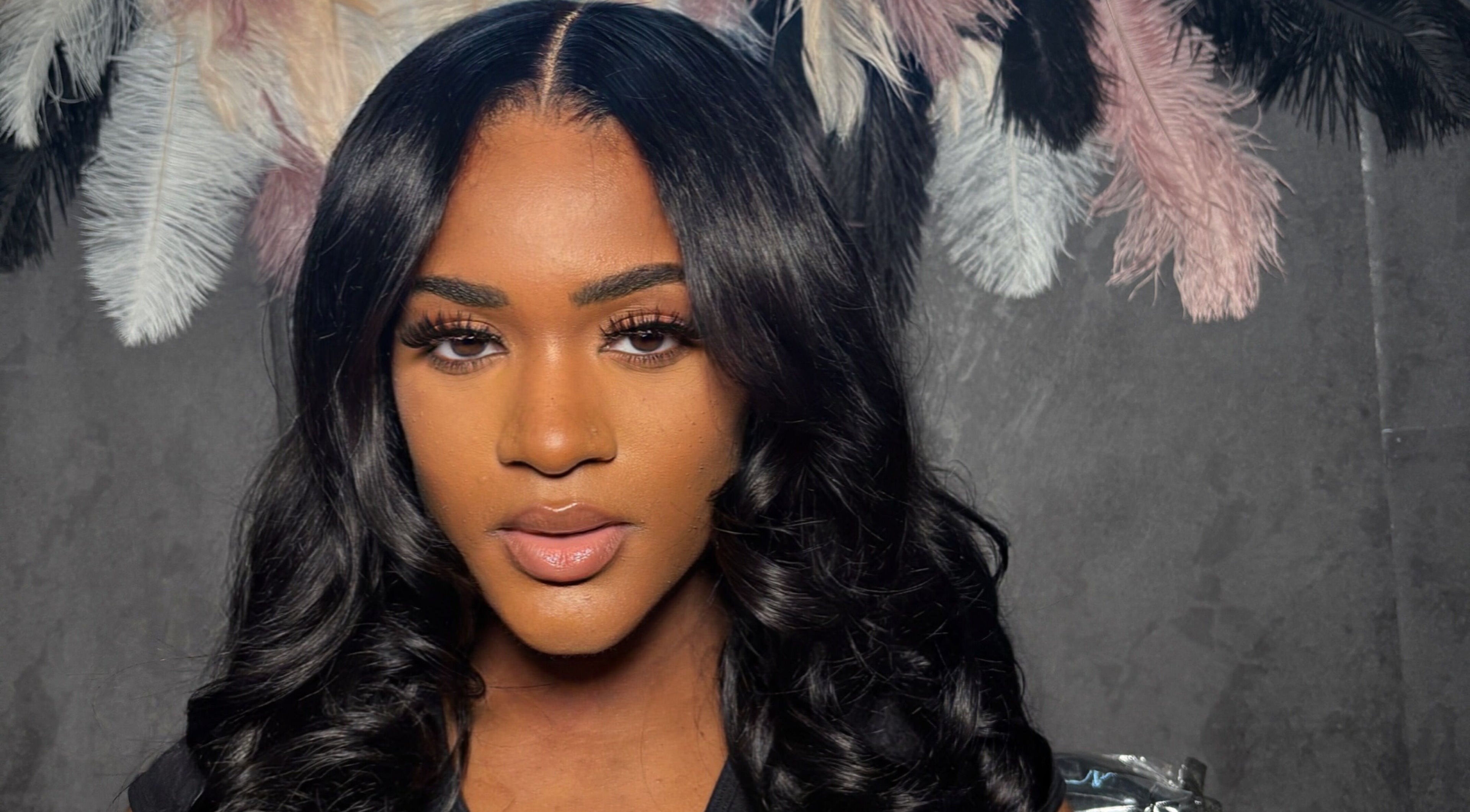 Professional hair styling at ChicBy.Te, Oistins, Christ Church, BB, showcasing sleek curls and feathered decor.