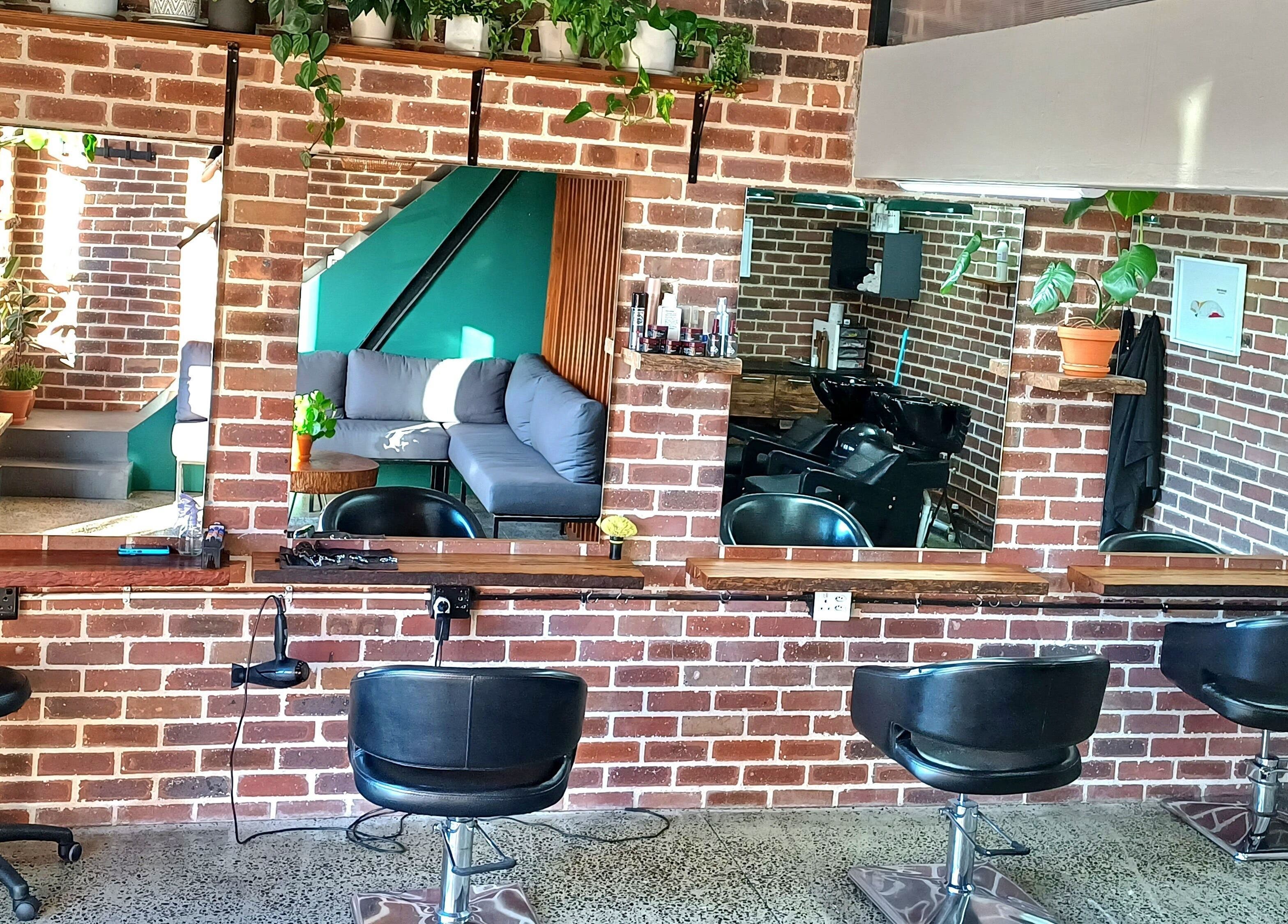 Stylish salon interior at The Hadfield Hair in Cape Town, Western Cape, ZA with modern decor and seating.