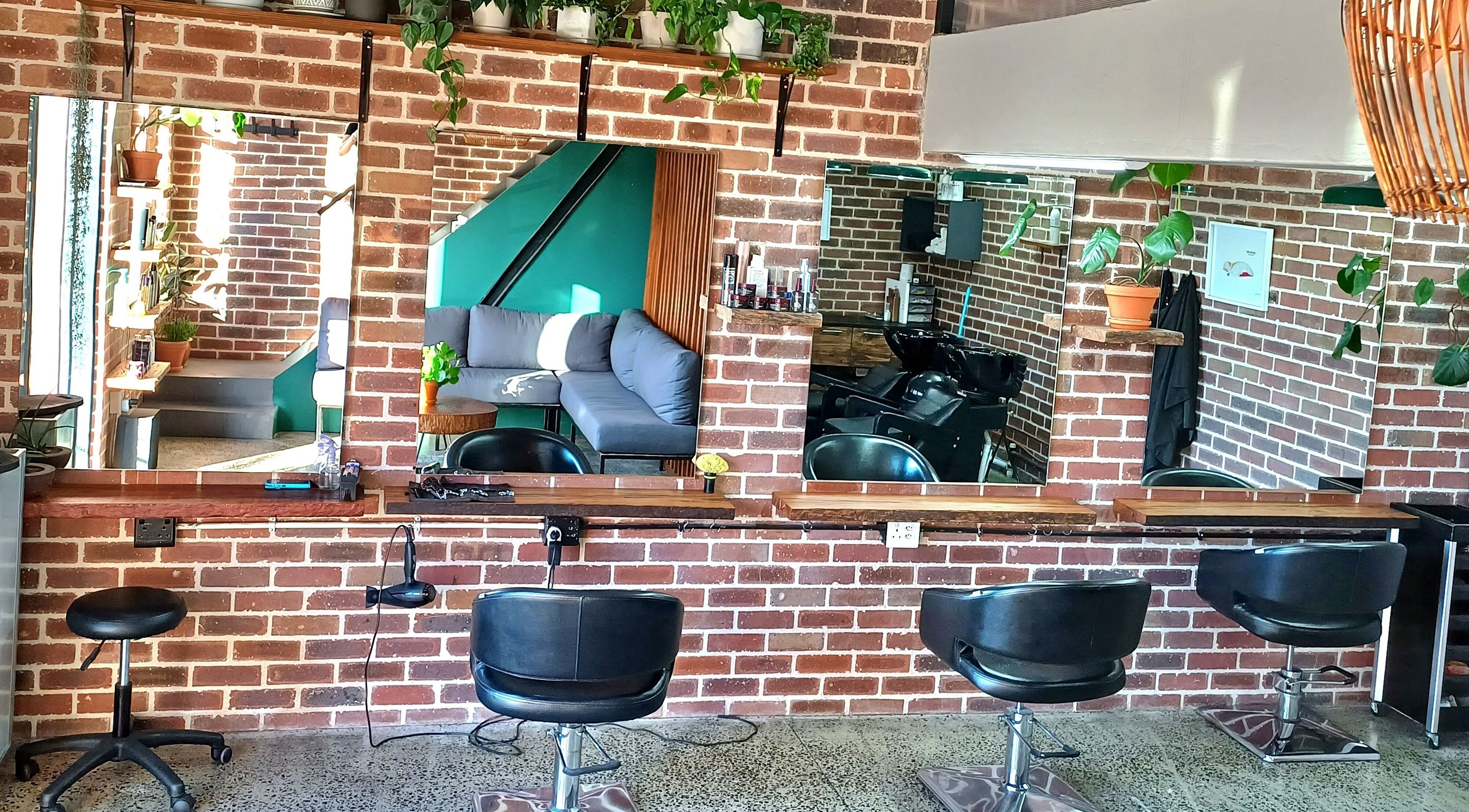 Stylish salon interior at The Hadfield Hair in Cape Town, Western Cape, ZA with modern decor and seating.