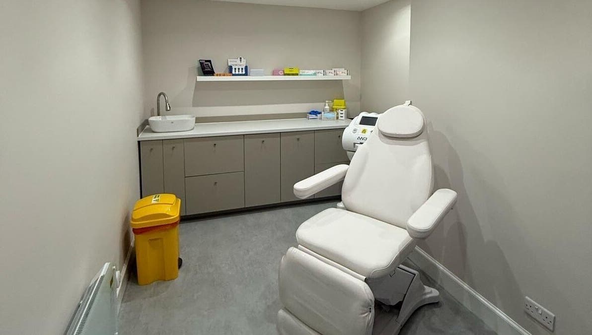 Modern treatment room at The Collective, Edinburgh, Scotland, GB featuring a white recliner and sleek cabinetry.