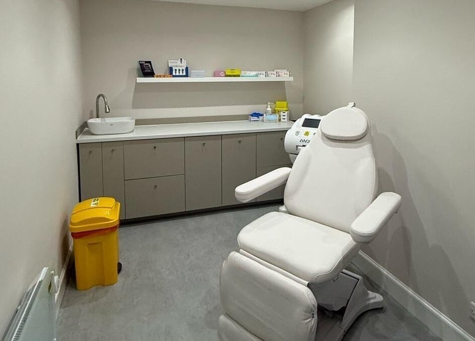 Modern treatment room at The Collective, Edinburgh, Scotland, GB featuring a white recliner and sleek cabinetry.
