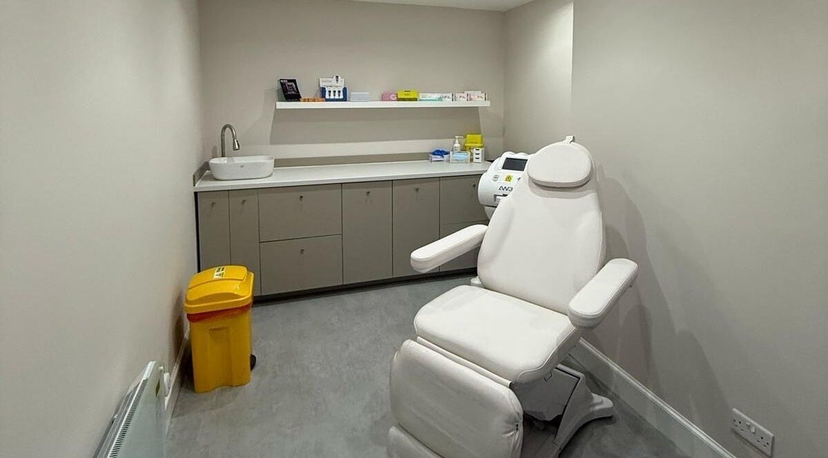 Modern treatment room at The Collective, Edinburgh, Scotland, GB featuring a white recliner and sleek cabinetry.