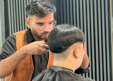 Expert stylist at Platinum Cutz & Style - WEST in Bouna Vista, Singapore, SG crafting a precise haircut.