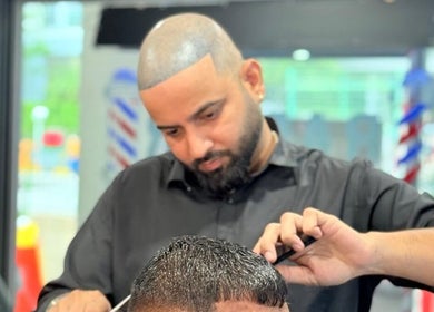 Barber expertly cutting hair at Platinum Cutz & Style - WEST, Bouna Vista, Singapore, SG.