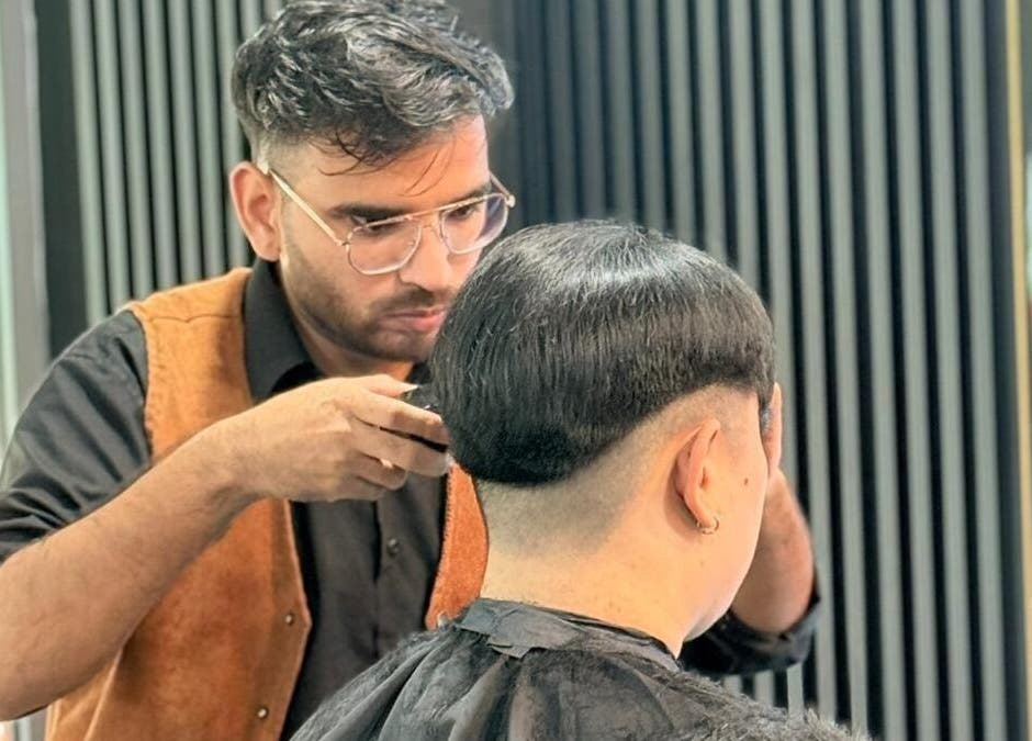 Expert stylist at Platinum Cutz & Style - WEST in Clementi, Singapore, SG, crafting a sharp haircut.