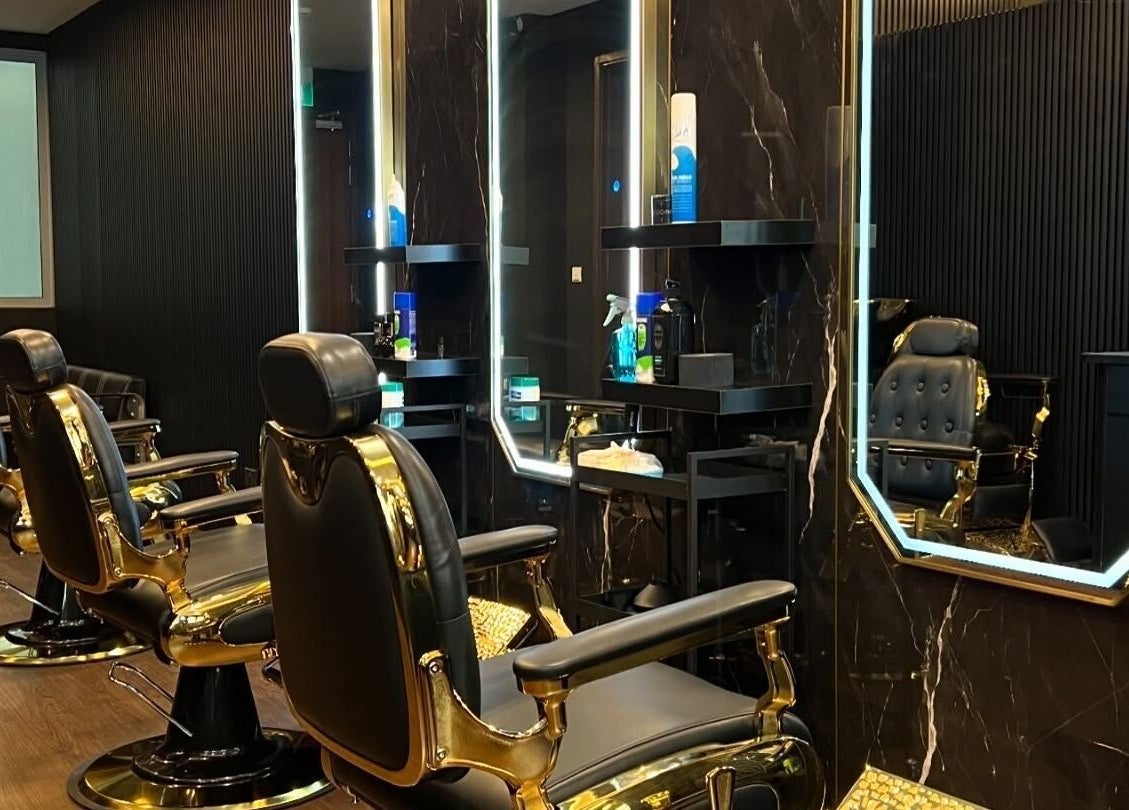Elegant salon interior at Platinum Cutz & Style - CENTRAL, Orchard, Singapore, SG with sleek black chairs.