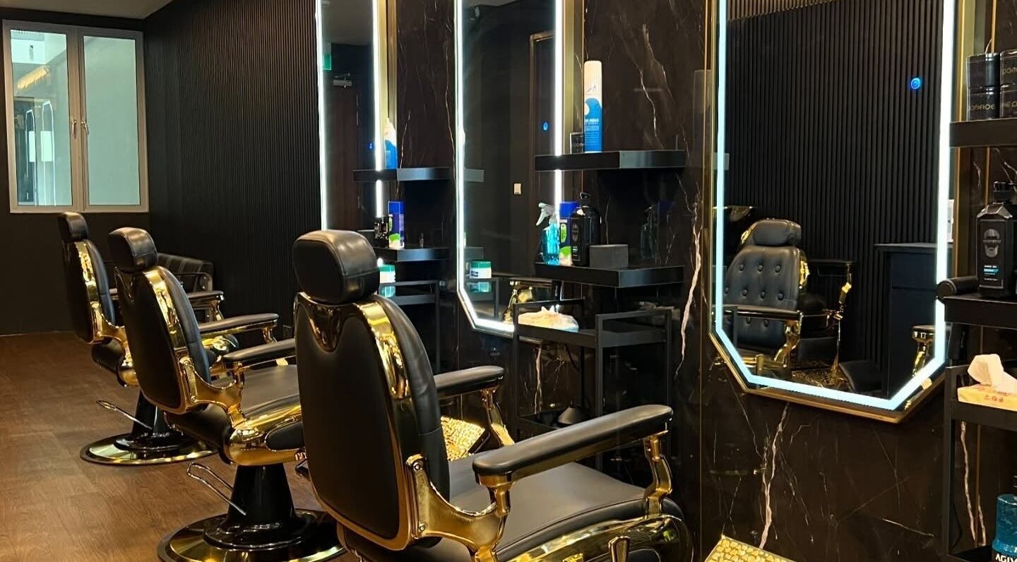 Elegant salon interior at Platinum Cutz & Style - CENTRAL, Orchard, Singapore, SG with sleek black chairs.