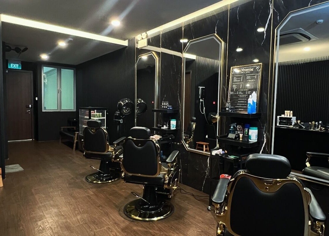 Luxurious interior of Platinum Cutz & Style - CENTRAL, Orchard, Singapore, SG with sleek barber chairs and mirrors.