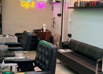 Interior of Platinum Cutz & Style - EAST, Marine Parade, Singapore, SG with sleek black chairs and modern decor.