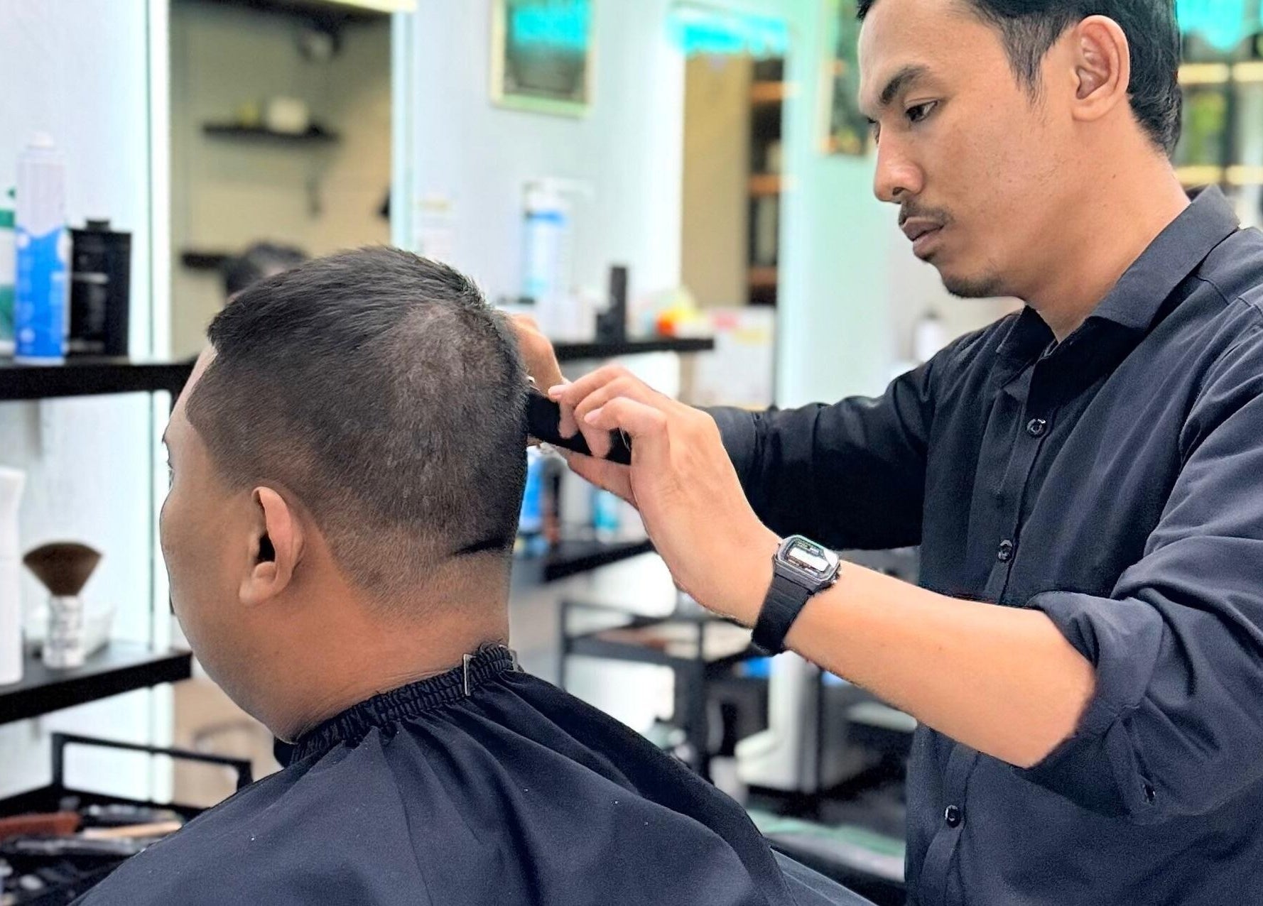 Barber at Platinum Cutz & Style - EAST Marine Parade, Singapore, SG giving a precise haircut to a client.