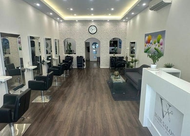 Modern interior of V Hair Salon Bondi, Bondi, New South Wales, AU with stylish chairs and decor.