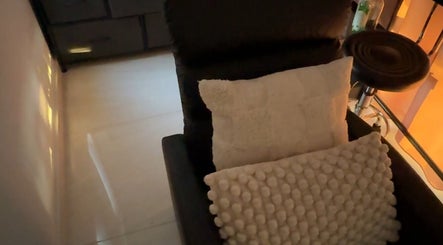 A comfortable chair with pillows at OnFleek Lash & Brows, Condell Park, New South Wales, AU.