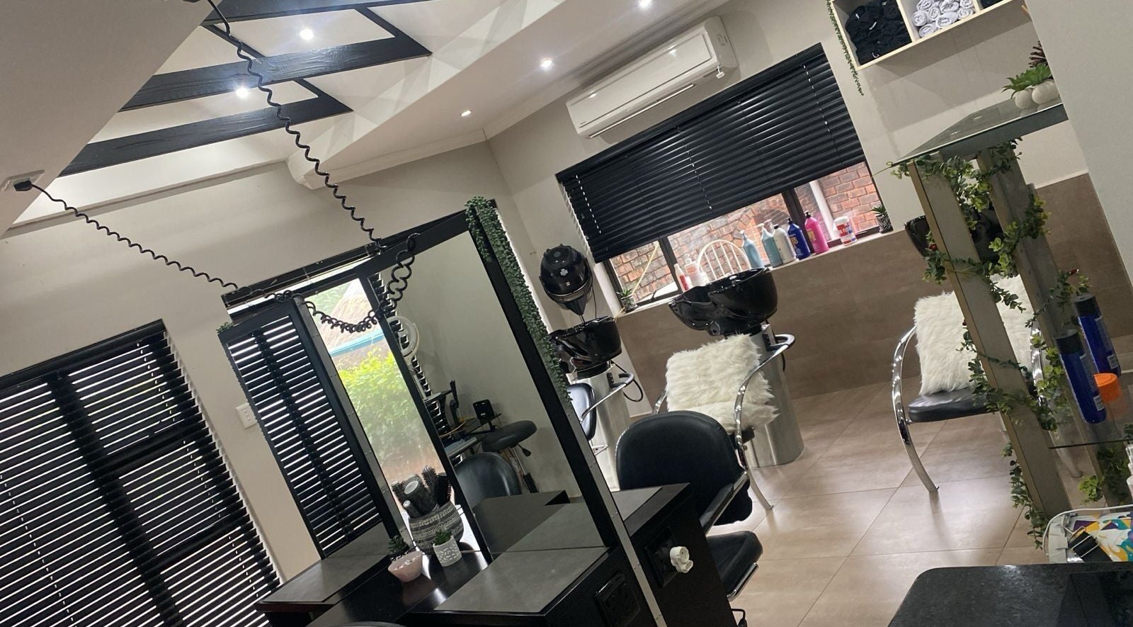 Modern salon interior at Twenty2onqueens, Kloof, Kwazulu-natal, ZA with sleek workstations and wash basins.