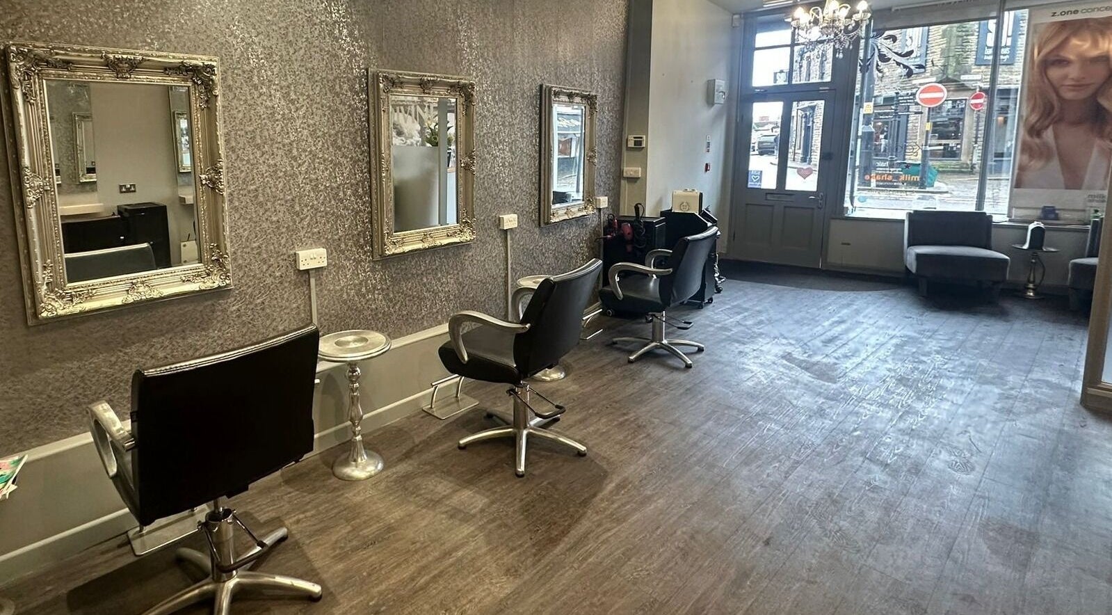 Chic interior of Divine Hair in Knaresborough, England, GB with stylish chairs and ornate mirrors.