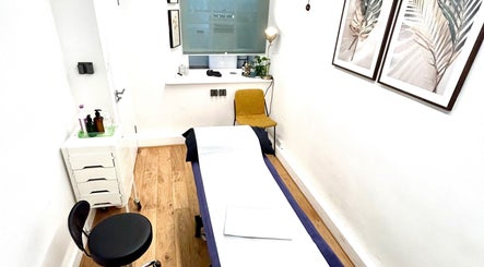 Tranquil massage room at Wellbeing Massage & Pain Relief in Covent Garden, London, England, GB with minimal decor.