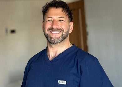 Smiling therapist at Wellbeing Massage & Pain Relief, Covent Garden, London, England, GB.