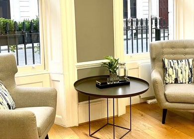 Cozy seating area with armchairs at Wellbeing Massage & Pain Relief in Covent Garden, London, England, GB.