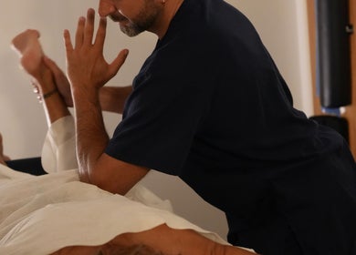 Massage therapist at Wellbeing Massage & Pain Relief in Covent Garden, London, England, GB, performing leg therapy.