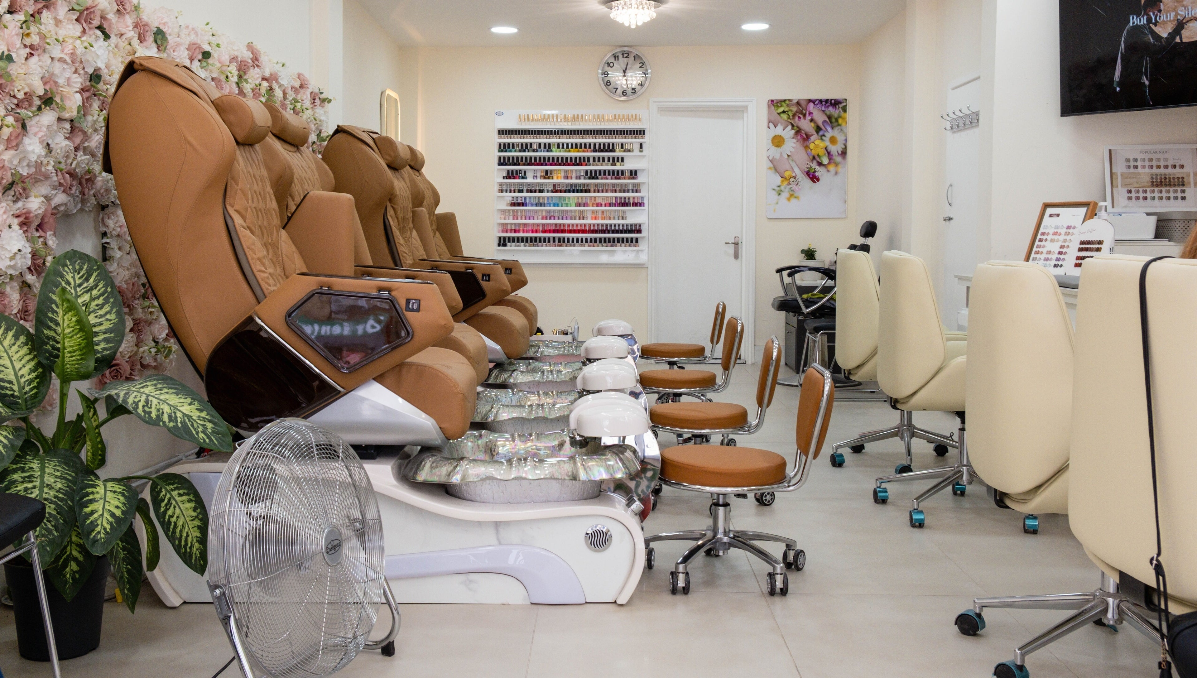 Luxurious pedicure chairs at Planet Nails, London, England, GB, with elegant interior and floral decor.