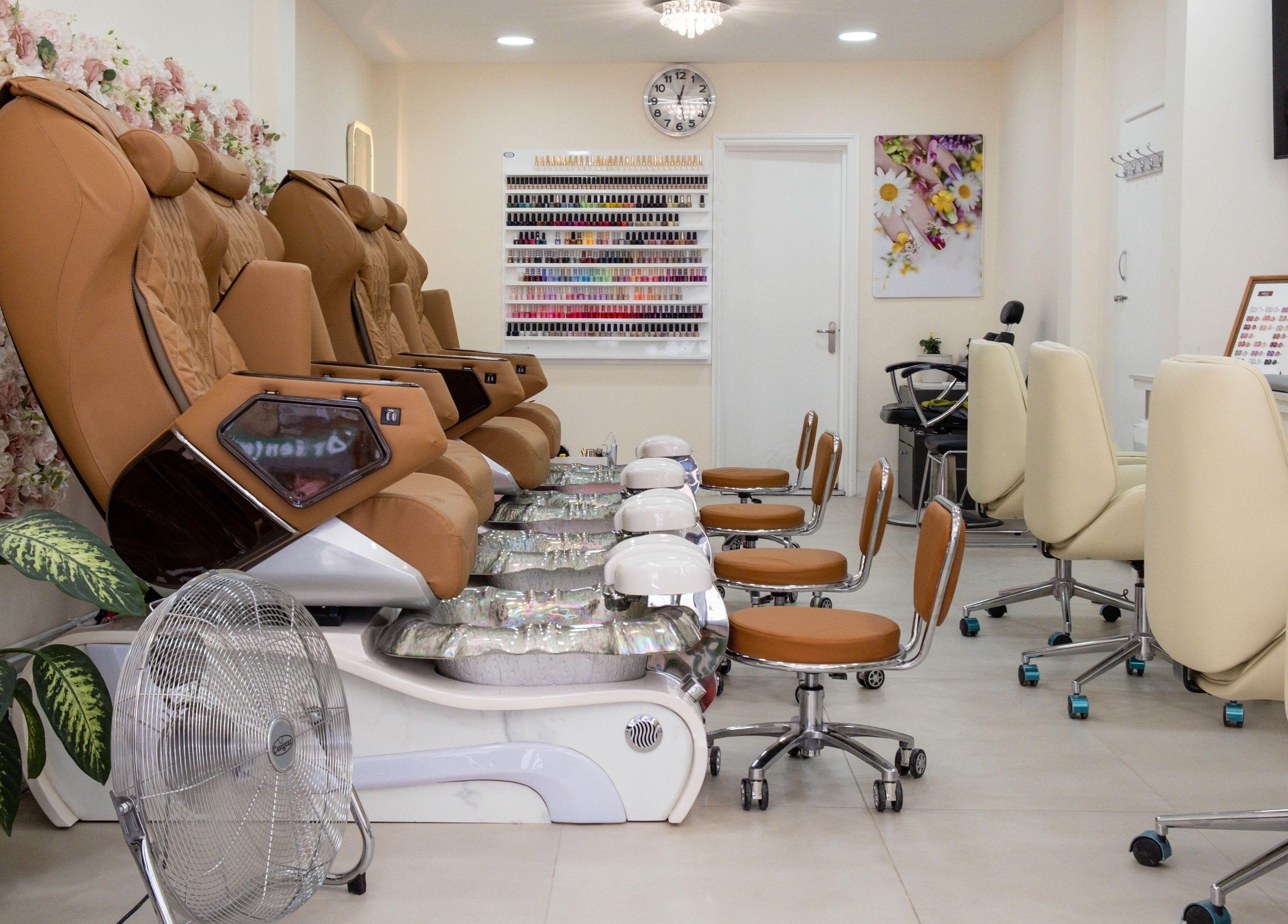 Luxurious pedicure chairs at Planet Nails, London, England, GB, with elegant interior and floral decor.