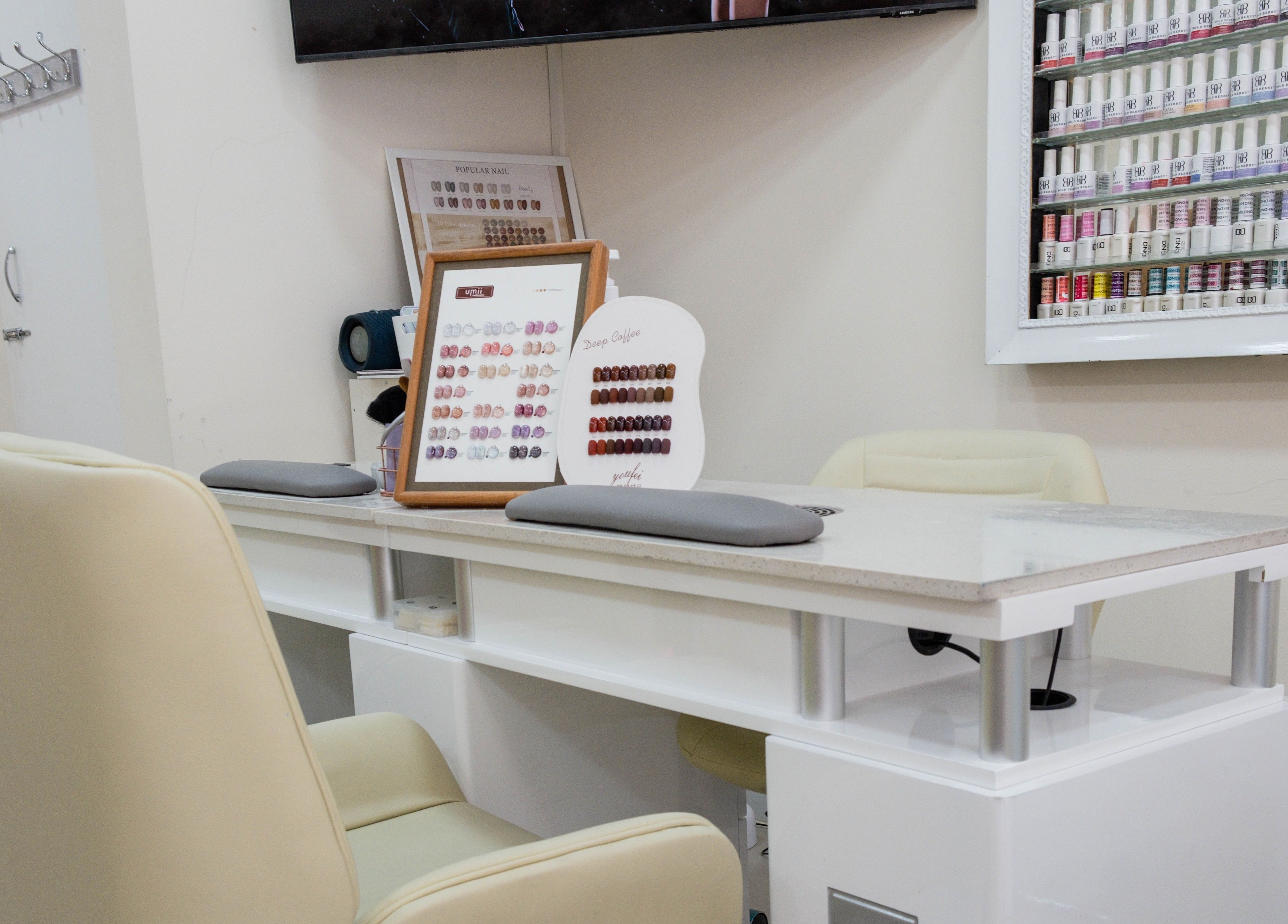 Modern nail salon at Planet Nails in London, England, GB showcasing elegant manicure station and nail polish collection.