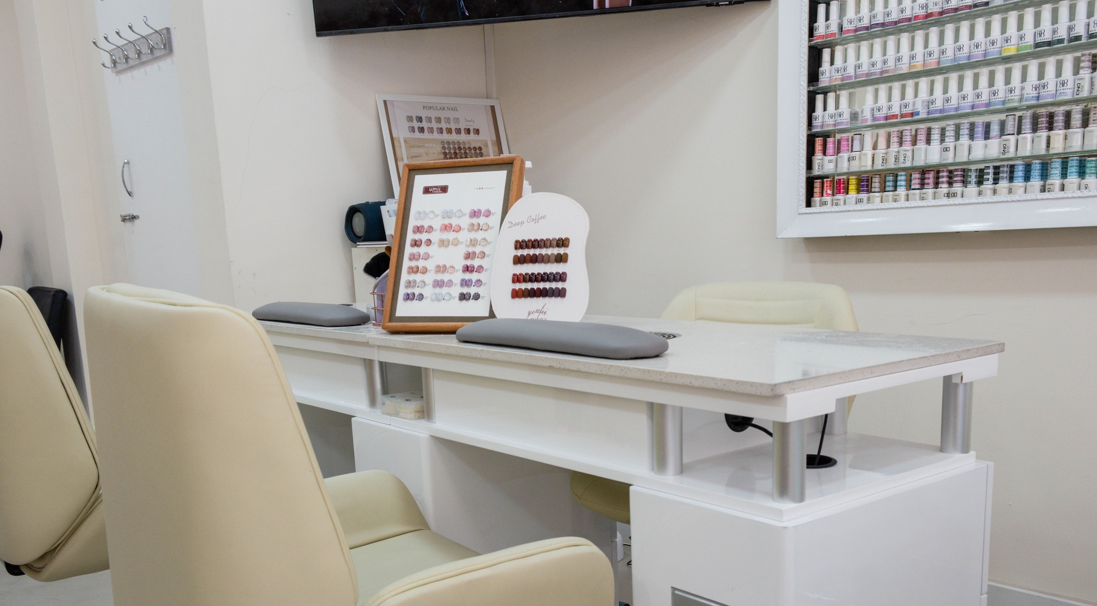 Modern nail salon at Planet Nails in London, England, GB showcasing elegant manicure station and nail polish collection.