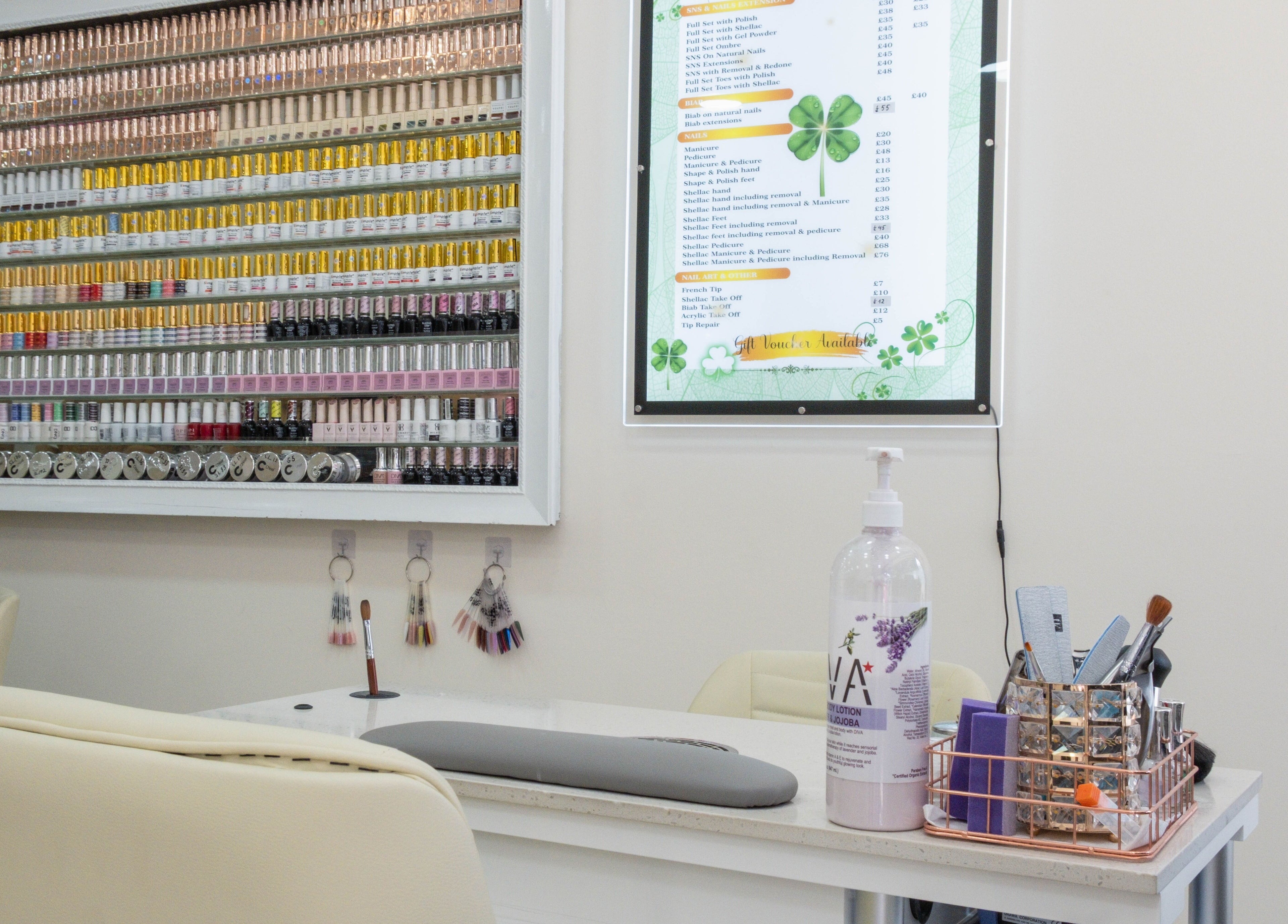 Wall of vibrant nail polishes and service menu at Planet Nails, London, England, GB.