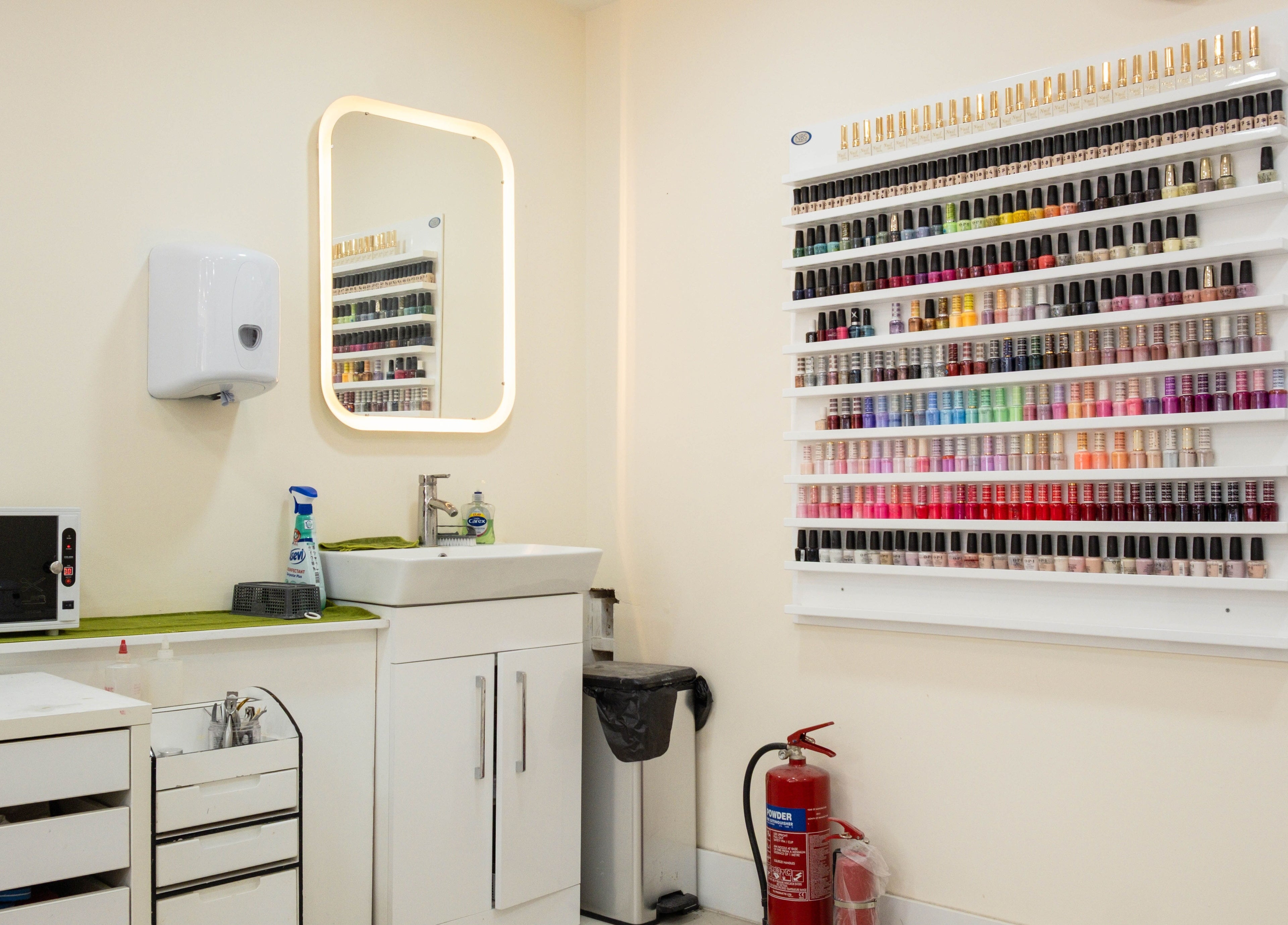 Interior of Planet Nails in London, England, GB featuring a vibrant wall display of nail polishes.