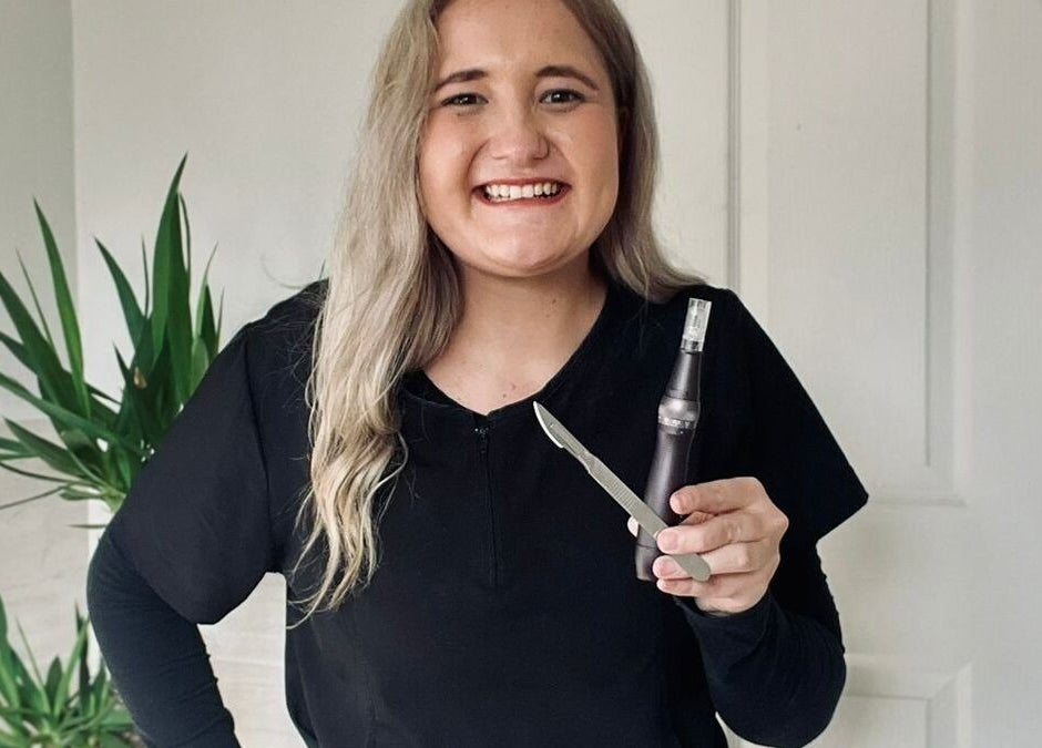 Smiling professional at KreaSkin in Emanzimtoti, Kwazulu-natal, ZA holding skincare tools.