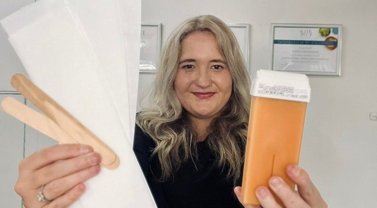 KreaSkin staff in Emanzimtoti holding waxing supplies, showcasing beauty services in Kwazulu-natal, ZA.