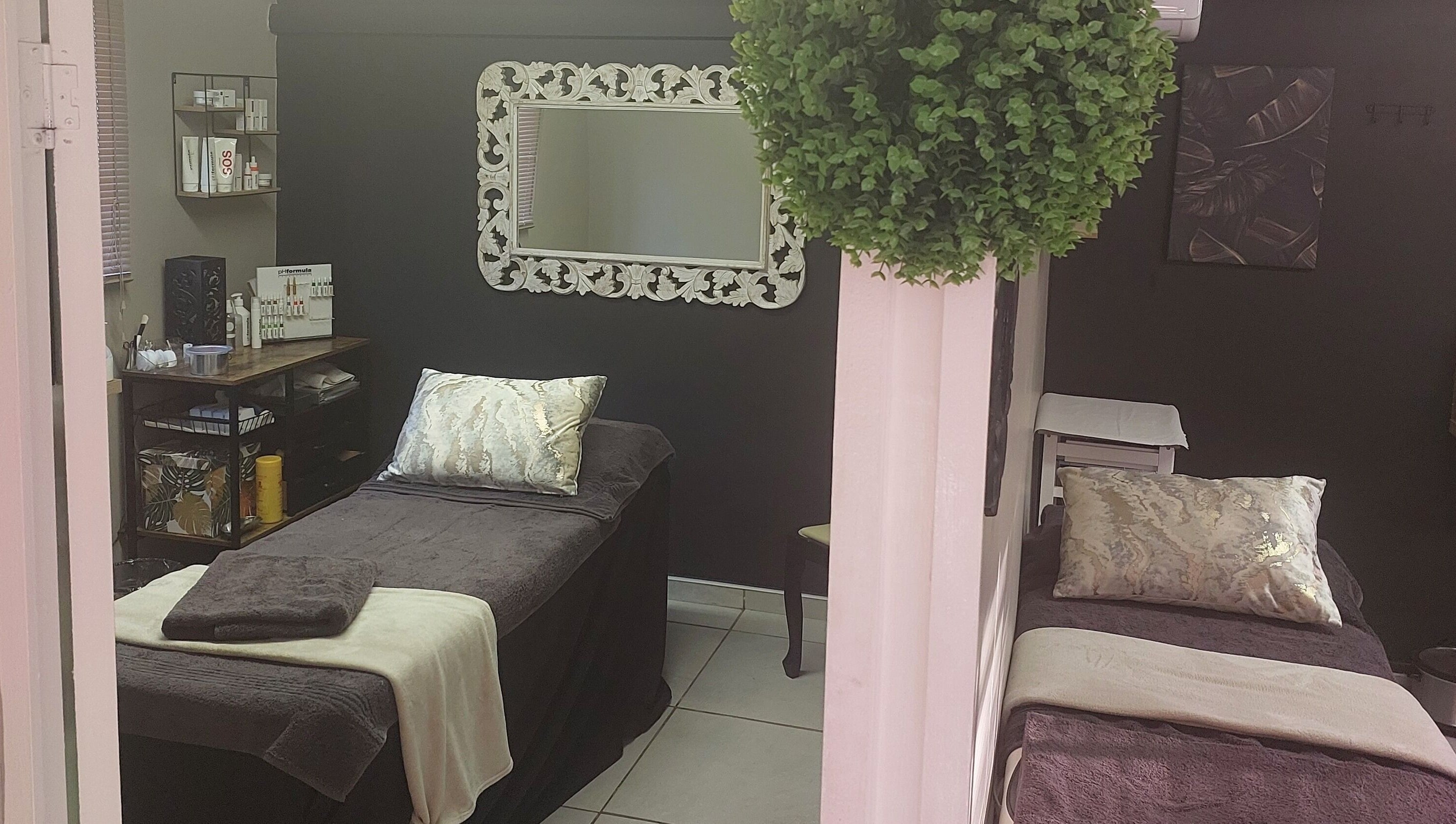 Relaxing spa room at Casey's Place Of Beauty, Pinetown, KwaZulu-Natal, ZA with elegant decor and treatment beds.
