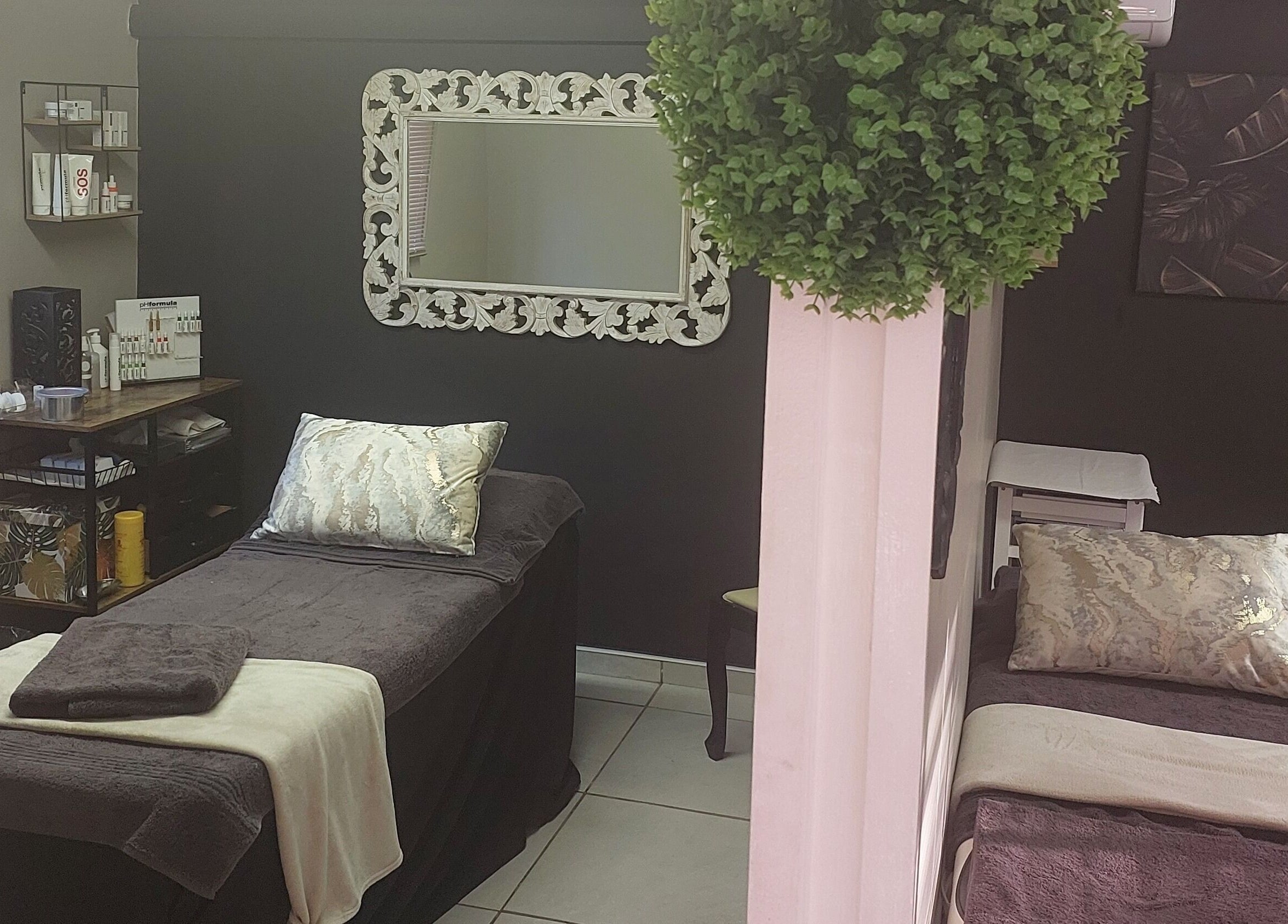 Relaxing spa room at Casey's Place Of Beauty, Pinetown, KwaZulu-Natal, ZA with elegant decor and treatment beds.