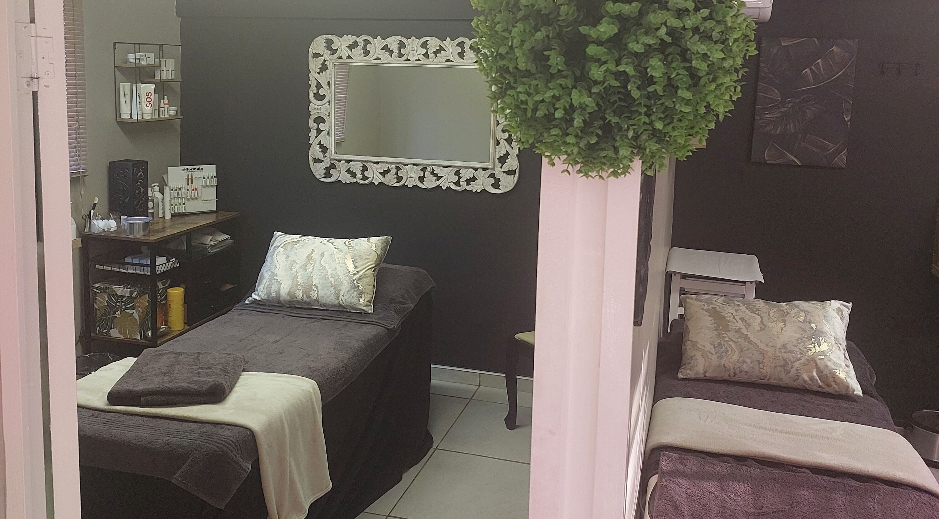 Relaxing spa room at Casey's Place Of Beauty, Pinetown, KwaZulu-Natal, ZA with elegant decor and treatment beds.