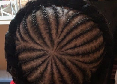 Intricate spiral cornrows hairstyle by Kay’s Braiding in Portmore, St. Catherine Parish, JM.